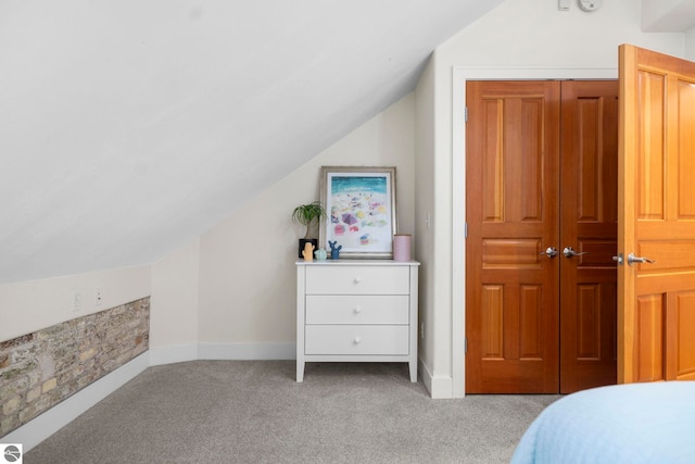 carpeted bedroom with vaulted ceiling