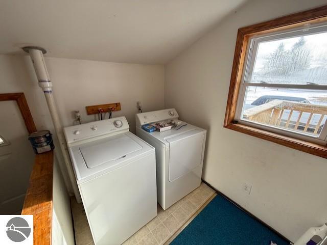 clothes washing area with washer and clothes dryer