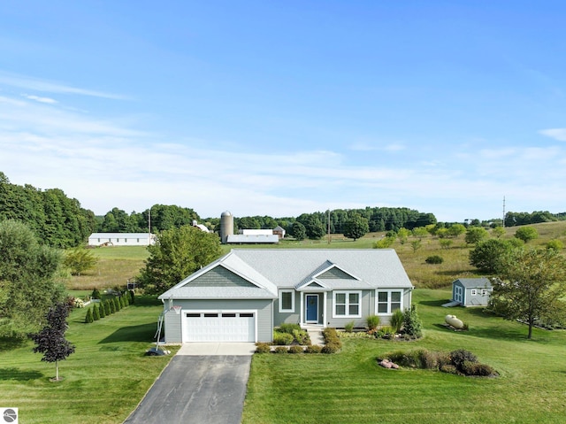 single story home featuring a garage and a front lawn