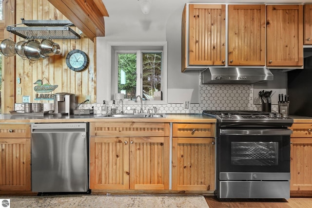 kitchen featuring appliances with stainless steel finishes, sink, and decorative backsplash