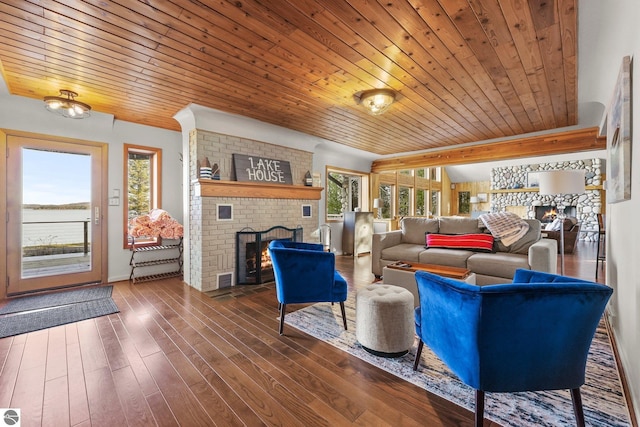 living room with dark wood-type flooring, wood ceiling, and a brick fireplace