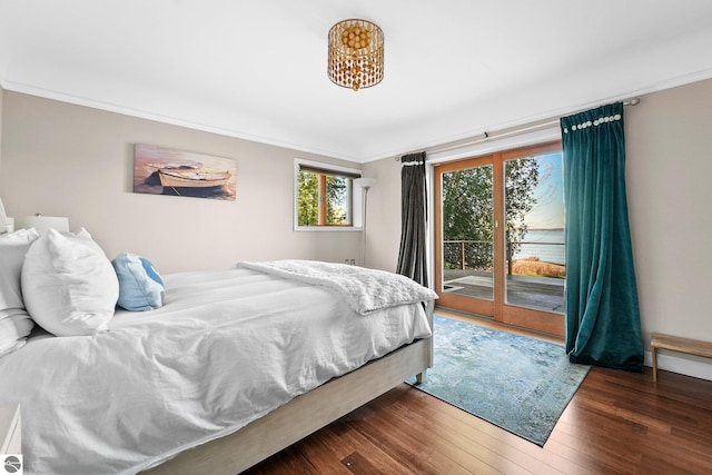 bedroom with access to exterior, dark wood-type flooring, and ornamental molding