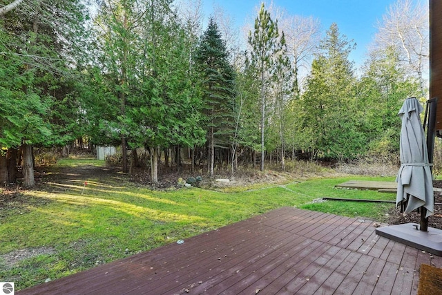 wooden deck with a lawn