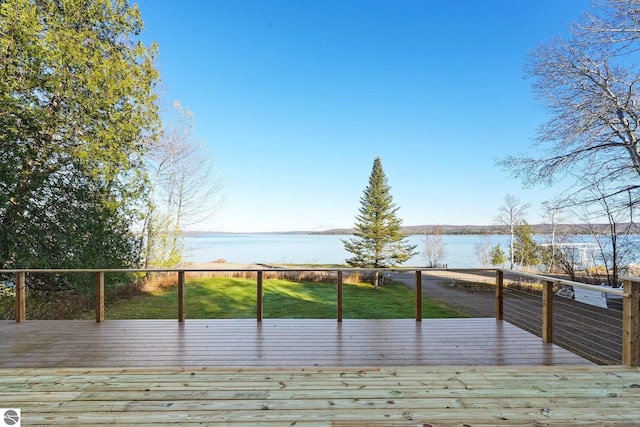 wooden deck with a yard and a water view