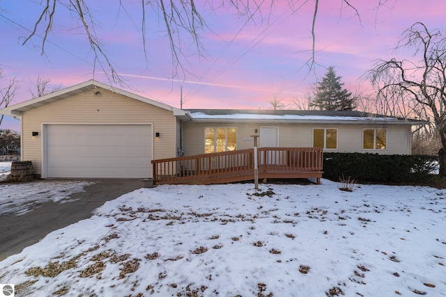 single story home with a garage and a wooden deck