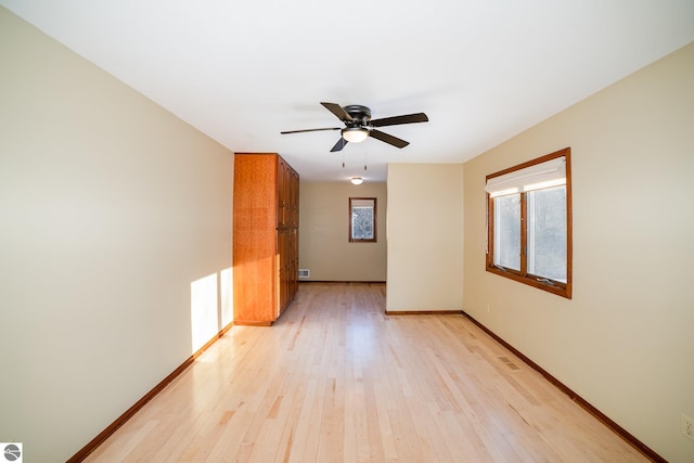 spare room featuring ceiling fan, plenty of natural light, and light hardwood / wood-style floors