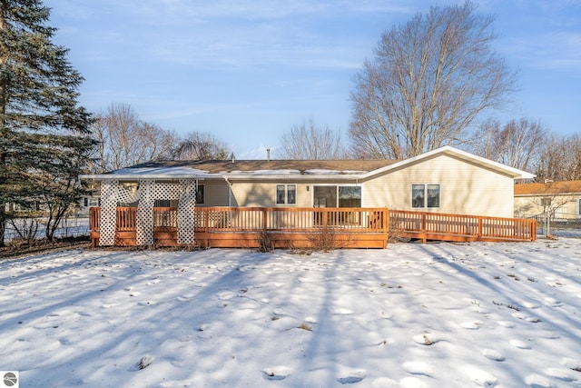 snow covered house featuring a deck