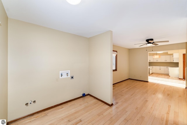 laundry room with hookup for a gas dryer, ceiling fan, electric dryer hookup, and light wood-type flooring