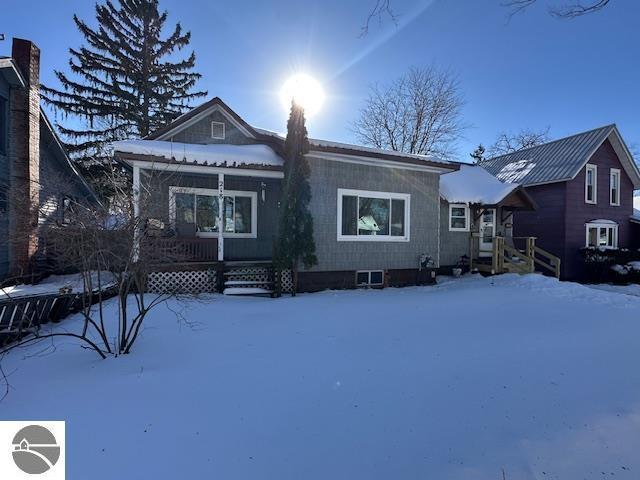 view of snow covered rear of property