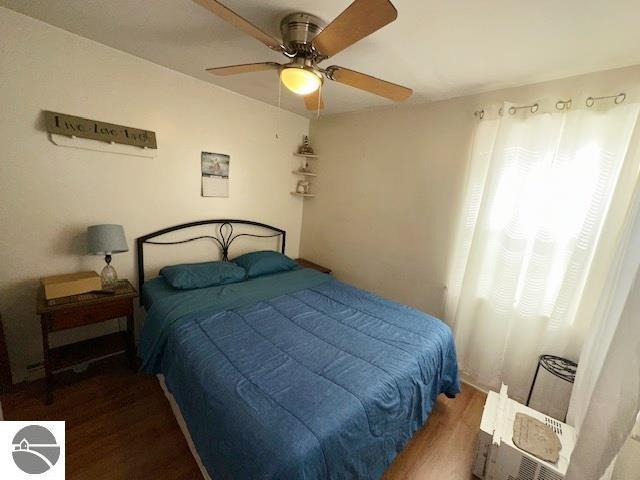 bedroom with dark wood-type flooring and ceiling fan