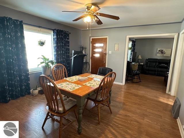 dining space with ceiling fan and hardwood / wood-style floors