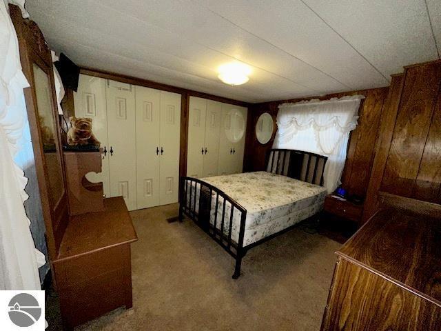 carpeted bedroom with multiple closets