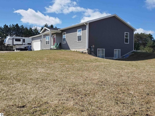 view of front of house with a garage and a front lawn