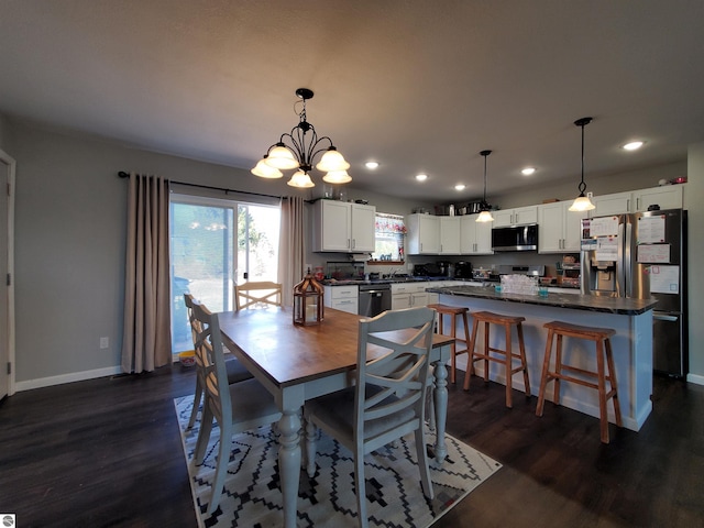 dining area with dark hardwood / wood-style floors and sink