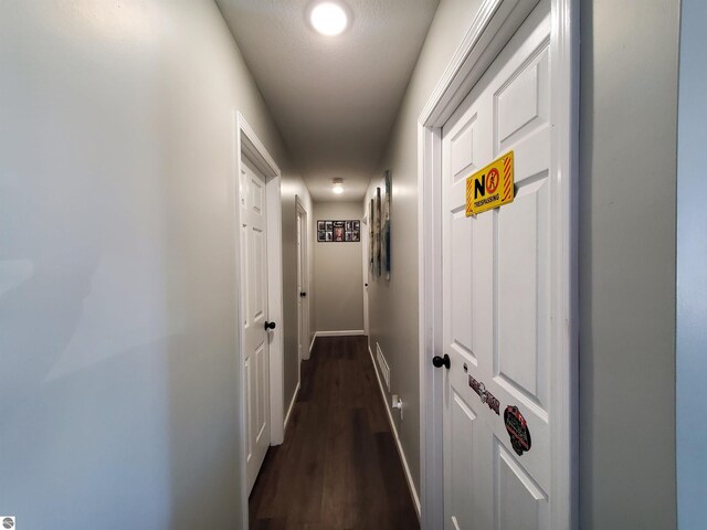 hall with dark hardwood / wood-style flooring