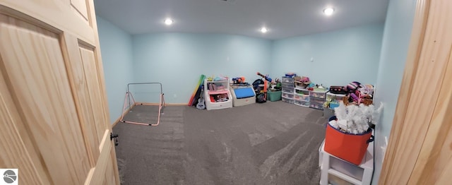 playroom featuring dark colored carpet