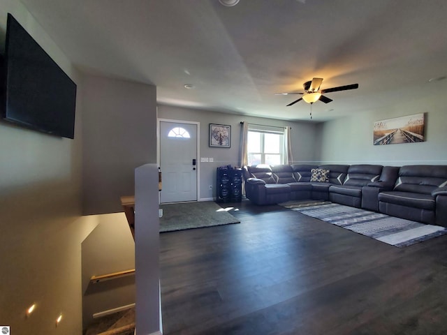 living room with dark wood-type flooring and ceiling fan