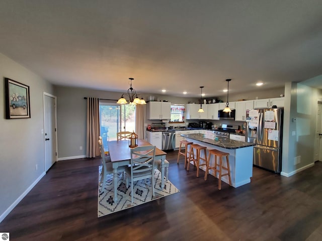 dining space featuring dark hardwood / wood-style flooring and a chandelier