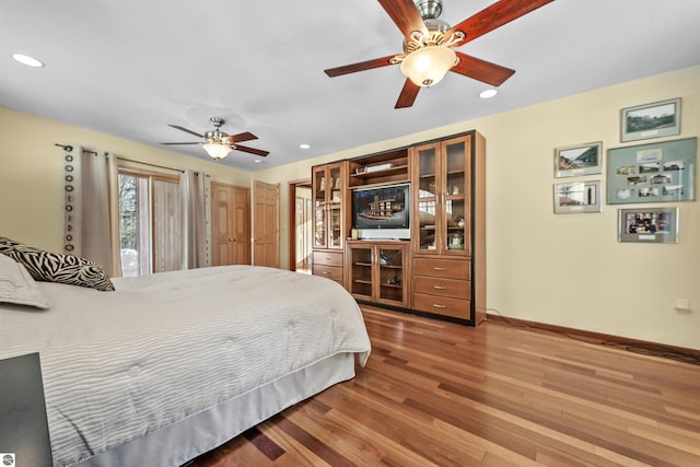 bedroom with hardwood / wood-style flooring and ceiling fan