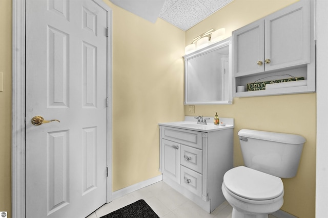 bathroom featuring tile patterned floors, vanity, and toilet