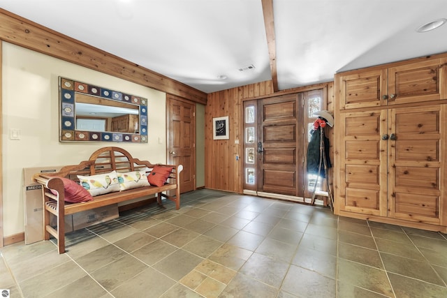 foyer entrance with wooden walls