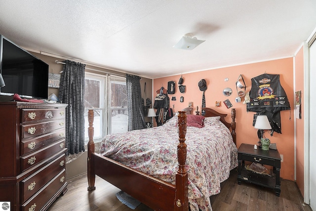 bedroom featuring wood-type flooring and a textured ceiling