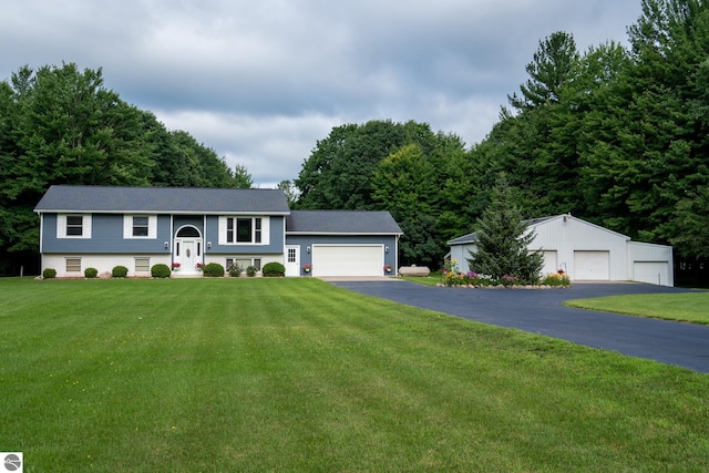 raised ranch with a garage and a front lawn