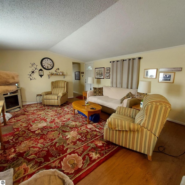 living room featuring lofted ceiling, carpet floors, and a textured ceiling