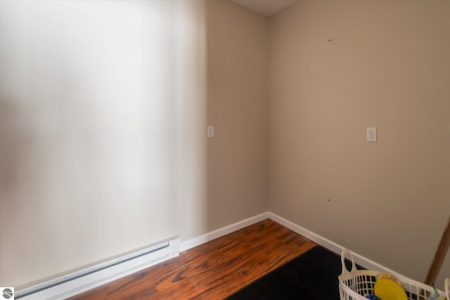 spare room featuring hardwood / wood-style flooring and a baseboard radiator