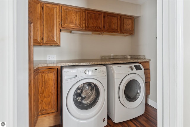 laundry room featuring cabinets and washing machine and clothes dryer