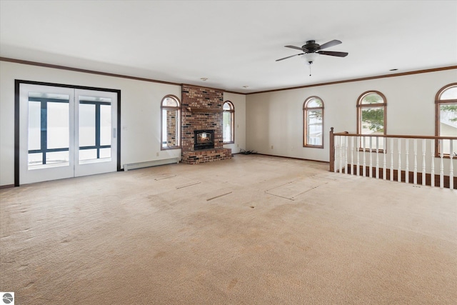 unfurnished living room with a baseboard radiator, a brick fireplace, ornamental molding, and light carpet