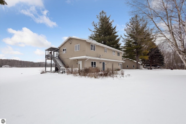 view of snow covered rear of property