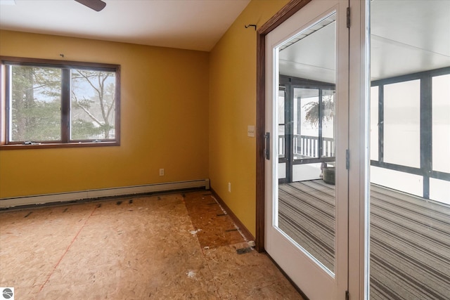 spare room with ceiling fan, a baseboard radiator, and a wealth of natural light