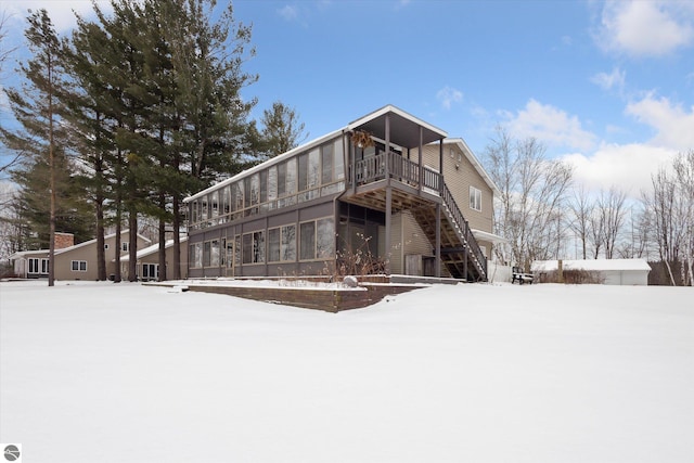 snow covered property with a balcony