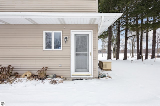 view of snow covered property entrance