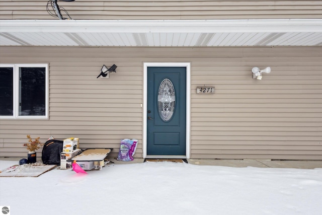 view of snow covered property entrance