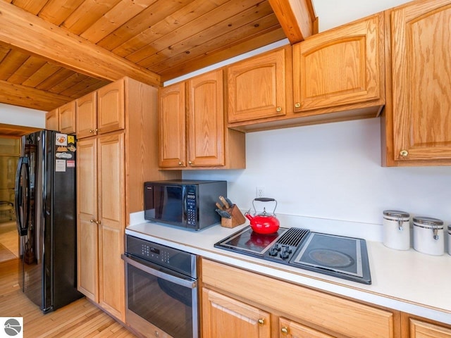 kitchen with beam ceiling, black appliances, light hardwood / wood-style floors, and wooden ceiling