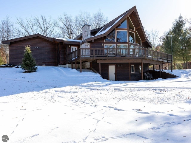 snow covered house with a deck