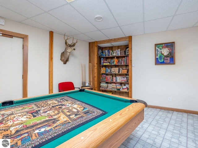 game room with a paneled ceiling