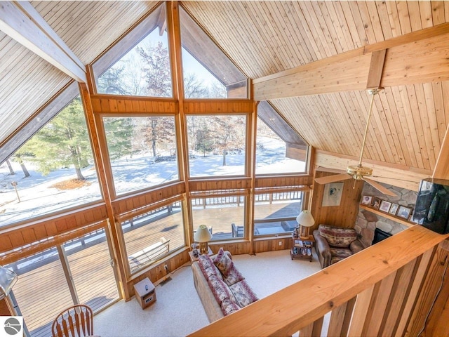 living room featuring plenty of natural light, carpet flooring, high vaulted ceiling, and beam ceiling