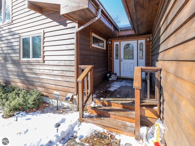 view of snow covered property entrance