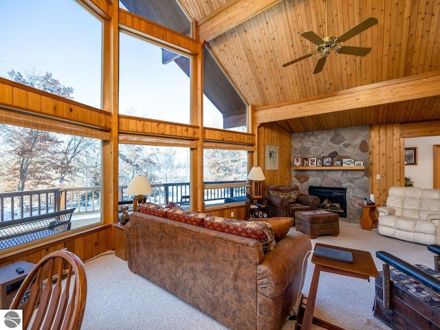 living room with beam ceiling, a wealth of natural light, carpet, and wooden ceiling