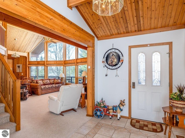 foyer entrance with a notable chandelier, light carpet, wooden ceiling, and beam ceiling