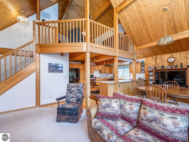 carpeted living room featuring beam ceiling, high vaulted ceiling, and wooden ceiling