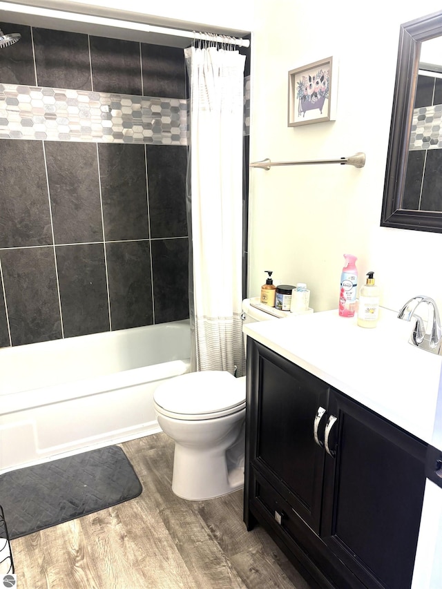 full bathroom with shower / bathtub combination with curtain, vanity, toilet, and hardwood / wood-style floors