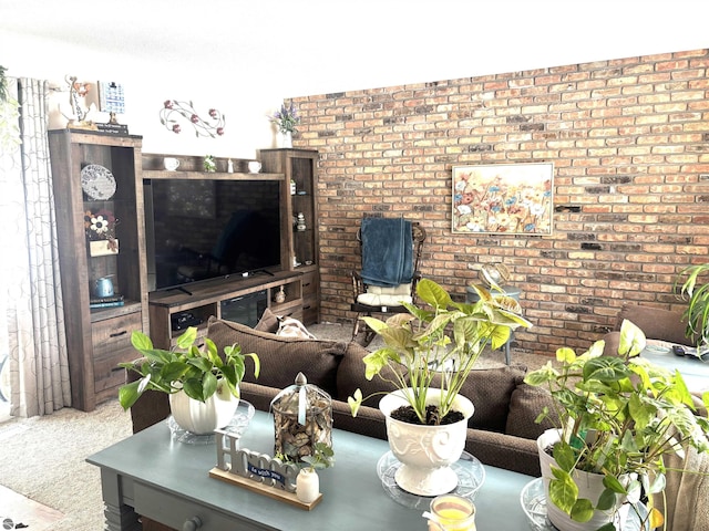 living room featuring brick wall and carpet floors