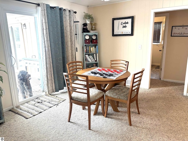 dining room with plenty of natural light and light colored carpet