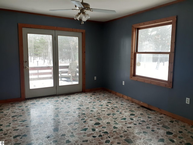 spare room with ornamental molding and ceiling fan