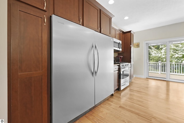 kitchen featuring light hardwood / wood-style floors and appliances with stainless steel finishes