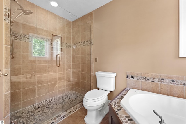 bathroom featuring toilet, plus walk in shower, and tile patterned flooring